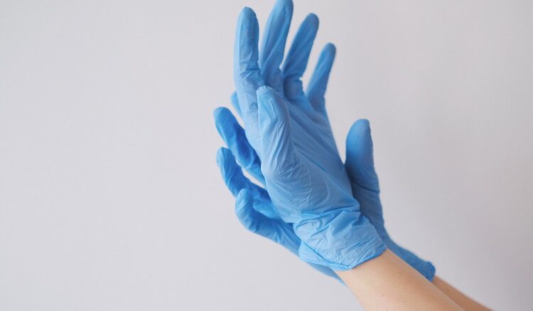 closeup-shot-person-s-hands-wearing-blue-gloves-750x437